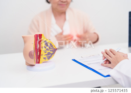 Elderly woman Patient consultation with doctor for Breast Augmentation Surgery, October Breast Cancer Awareness month, implant, Diagnosis, Beauty woman enlargement and medical healthcare concept Elderly woman Patient consultation with doctor for Breast Augmentation Surgery, October Breast Cancer Awareness month, implant, Diagnosis, Beauty woman enlargement and medical healthcare concept 125571435