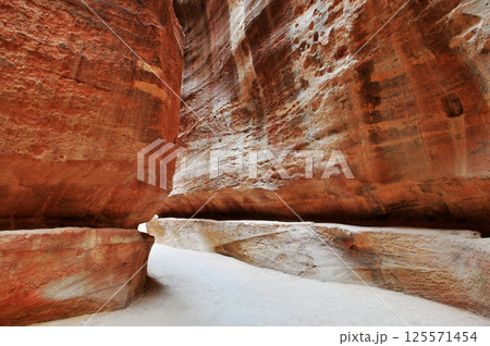 The ruins ancient path between cliffs in Petra, Jordan. The ruins ancient path between cliffs in Petra, Jordan. 125571454