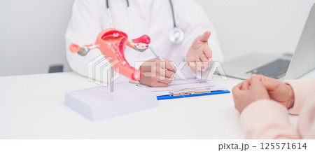 Woman patient consulting doctor with anatomy Uterus and Ovaries. Ovarian and Cervical cancer, Cervix disorder, Endometriosis, Hysterectomy, Uterine fibroids, Reproductive system and Pregnancy concept Woman patient consulting doctor with anatomy Uterus and Ovaries. Ovarian and Cervical cancer, Cervix disorder, Endometriosis, Hysterectomy, Uterine fibroids, Reproductive system and Pregnancy concept 125571614