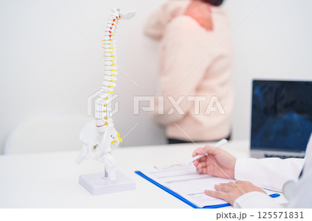 Elderly Patient consulting Doctor with Spine anatomy for Spinal Cord Disorder and disease, Back pain, Lumbar, Sacral pelvis, Cervical neck, Thoracic, Coccyx, Orthopedist, chiropractic, Office Syndrome Elderly Patient consulting Doctor with Spine anatomy for Spinal Cord Disorder and disease, Back pain, Lumbar, Sacral pelvis, Cervical neck, Thoracic, Coccyx, Orthopedist, chiropractic, Office Syndrome 125571831