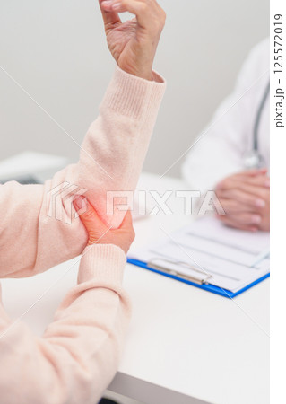 Elderly Woman having elbow ache and consulting doctor in hospital. muscle pain due to lateral epicondylitis or tennis elbow. injury, Health and medical consultation concept Elderly Woman having elbow ache and consulting doctor in hospital. muscle pain due to lateral epicondylitis or tennis elbow. injury, Health and medical consultation concept 125572019