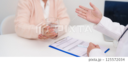 Senior woman with Tremor hand during taking glass of water in hospital. Parkinson disease April awareness month, Carpal Tunnel Syndrome, rheumatoid and brain injury and Neurological disorder concept Senior woman with Tremor hand during taking glass of water in hospital. Parkinson disease April awareness month, Carpal Tunnel Syndrome, rheumatoid and brain injury and Neurological disorder concept 125572034