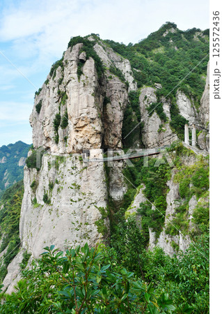 a suspension bridge on the edge of a cliff in the mountains, Zhejiang Province, China 125572436
