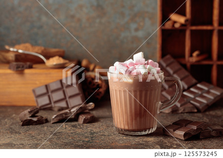 Hot chocolate drink with marshmallows on a brown background. 125573245