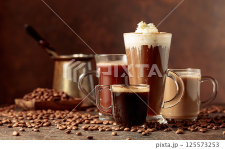Various coffee and chocolate drinks on a brown background. Various coffee and chocolate drinks on a brown background. 125573253