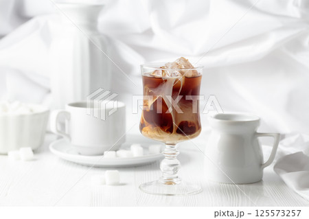 Iced coffee with cream and cup of black coffee. Iced coffee with cream and cup of black coffee. 125573257