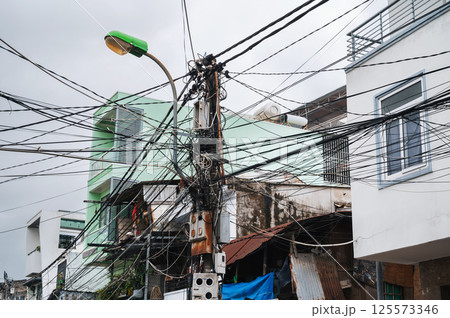 mess in electricity wires on street in city in Asia in Vietnam mess in electricity wires on street in city in Asia in Vietnam 125573346