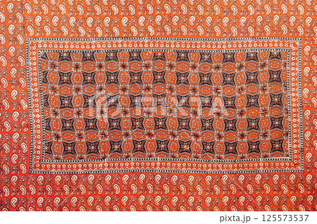 traditional Uzbek geometric pattern on ancient vintage carpet in Uzbekistan. Oriental background with beautiful ornaments 125573537
