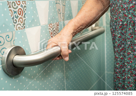 Asian elderly woman patient use toilet bathroom handle security in nursing hospital, healthy strong medical. Asian elderly woman patient use toilet bathroom handle security in nursing hospital, healthy strong medical. 125574085