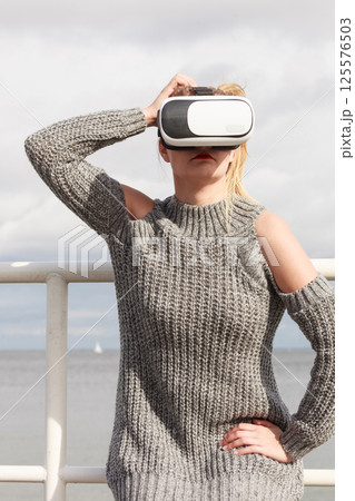 Woman wearing VR outside 125576503