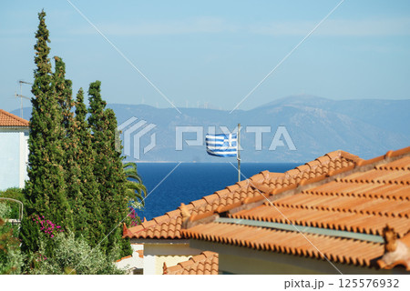 Greek flag on roof top of home Greek flag on roof top of home 125576932