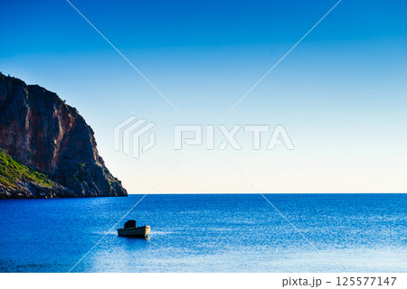 Motor boat anchored in bay 125577147