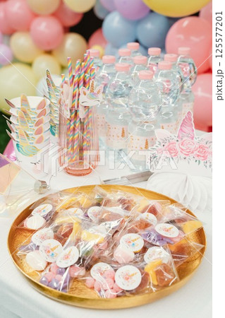 Unicorn-Themed Party Table with Treats and Decorations 125577201