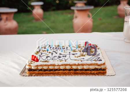 Celebration Cake with Blue Candles for a 10th Birthday Celebration Cake with Blue Candles for a 10th Birthday 125577208