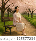 桜の下でベンチに座る女性 125577234
