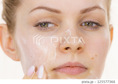 Girl apply cream cosmetic 125577368