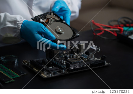 Hands repairing electronic devices. Electronic technician. 125578222