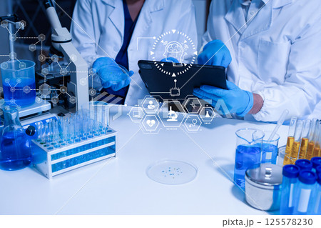 Lab work, Doctor holds a test tube takes the test from a test tube in analysis. 125578230