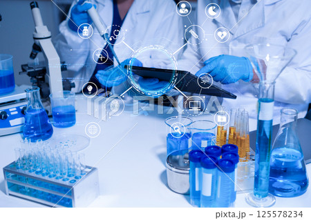 Lab work, Doctor holds a test tube takes the test from a test tube in analysis. 125578234
