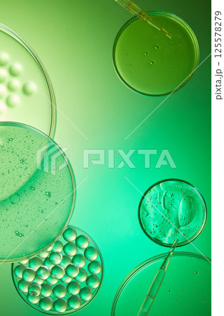 Bubbles of air or oxygen in the gel extracted from fresh gotu kola, tiny circles float on the surface.The transparent molecules of the liquid are placed in a glass tray, used for experiments. 125578279