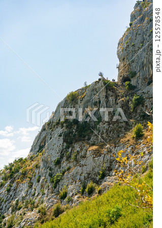 View from a green mountain under a sunny sky at Bovilla Lake in Albania near Tirana. View from a green mountain under a sunny sky at Bovilla Lake in Albania near Tirana. 125578548