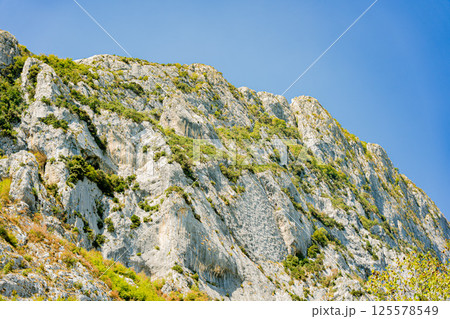 Mountainous landscape with a dam on the edge of the lake. Bovilla Lake - Albania. 125578549