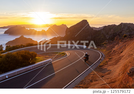 Motorcycle Driver Riding in High Mountain Landscape. Pico do Arieiro, Madeira Island. 125579172