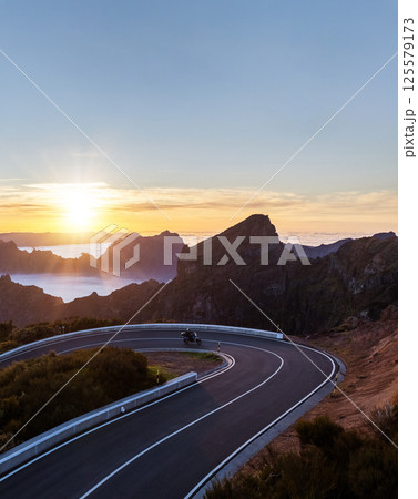 Motorcycle Driver Riding in High Mountain Landscape. Pico do Arieiro, Madeira Island. 125579173