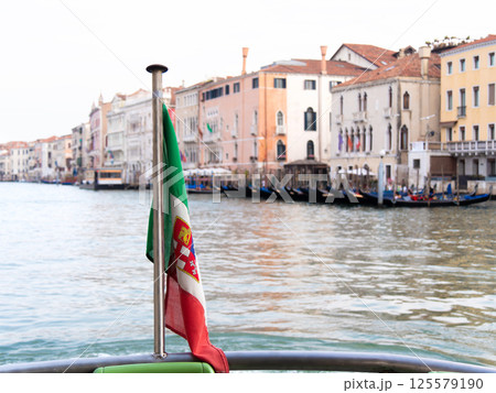 Italian flag view from boat on Venice canal Italian flag view from boat on Venice canal 125579190