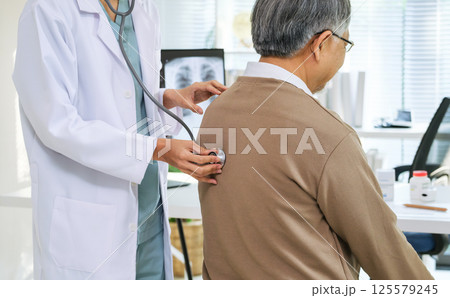 Doctor Using Stethoscope to Check Senior Patient's cardiology and respiratory in Hospital 125579245