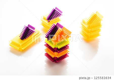 The elements of the children's construction set are presented in a full range of vibrant colors. The play-constructor parts are placed on a white background, creating a contrasting composition. The elements of the children's construction set are presented in a full range of vibrant colors. The play-constructor parts are placed on a white background, creating a contrasting composition. 125581634