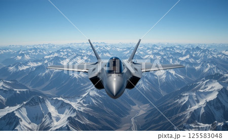 Front view of F-35 fighter jet soaring above snow-capped mountains. 125583048