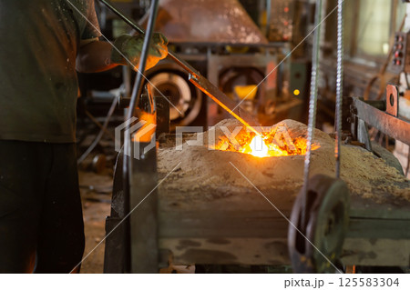 Ferrous metal billet is melted in an induction furnace closeup Ferrous metal billet is melted in an induction furnace closeup 125583304