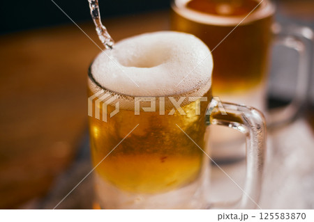 mug of beer on wooden table mug of beer on wooden table 125583870