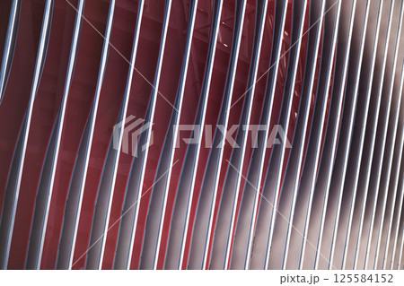 Cladding of a modern sports stadium against a blue sky 125584152