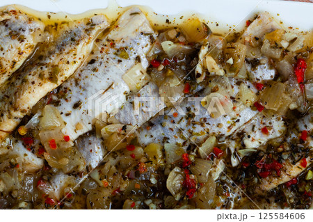 Breakfast or brunch. Plate with marinated herring in oil, sprinkled with spice 125584606