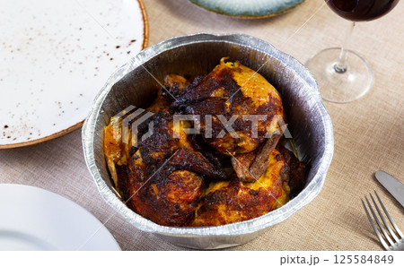 Fried chicken with baked potatoes served in foil Fried chicken with baked potatoes served in foil 125584849