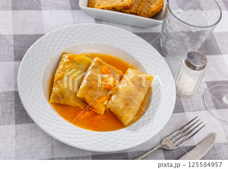 Stuffed cabbage rolls with filling on plate 125584957