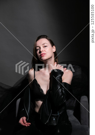 Beautiful woman in leather suit and black lingerie 125585100