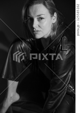 Beautiful woman in leather suit and black lingerie 125585102