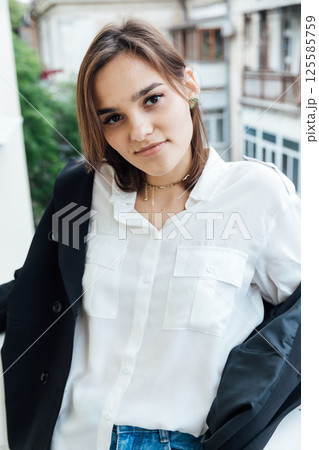 Portrait of a beautiful woman in a black jacket and hat Portrait of a beautiful woman in a black jacket and hat 125585759