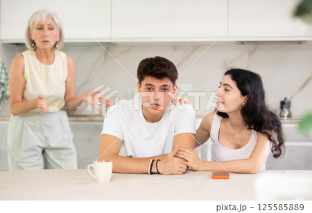 Elderly woman swears at young married couple 125585889