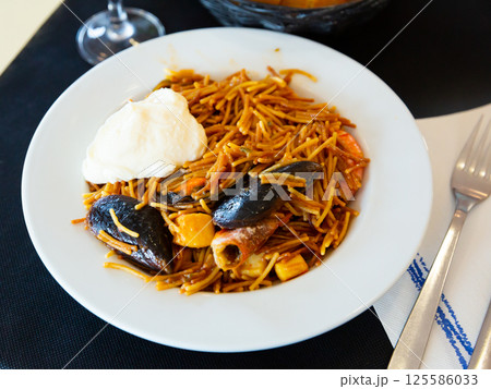 Fideua, noodle paella on white plate 125586033
