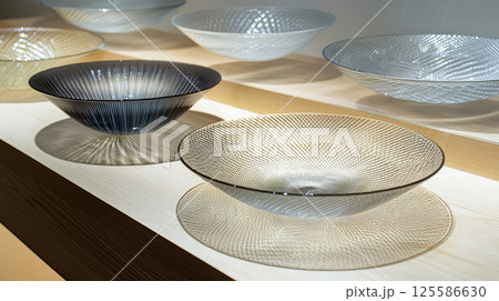 Eco-friendly decorative plates crafted from recycled glass in elegant display. concept of sustainable design, eco-conscious decor, innovative recycling, artistic tableware 125586630
