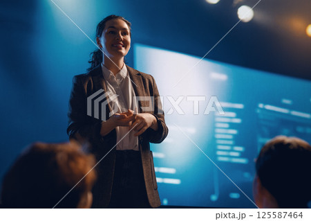 A woman is speaking on stage 125587464