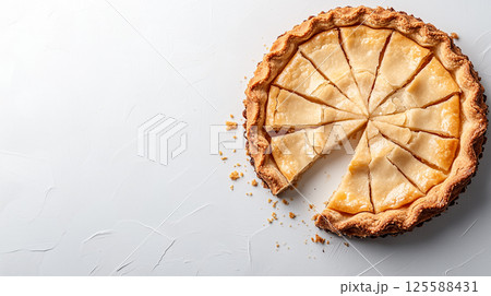 Freshly baked apple pie with a slice removed on textured white background 125588431