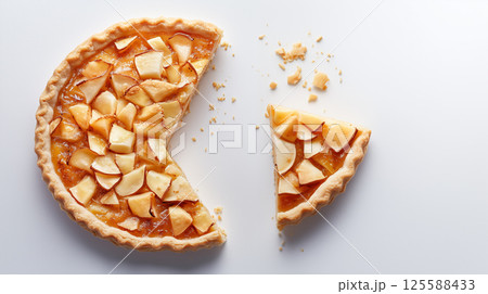 Top view of apple pie with one slice cut out on white background 125588433