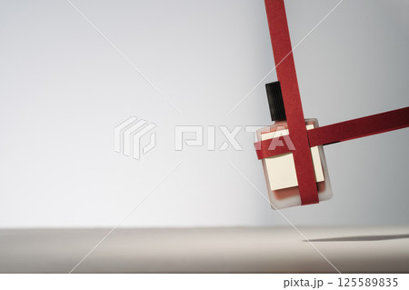 Blank beauty product with red paper ribbons. Minimalist mockup holiday product photo 125589835