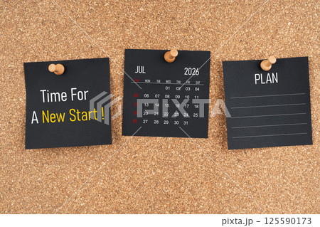 July 2026 calendar with Time for a new start and Plan text on black adhesive notes with wooden. 125590173
