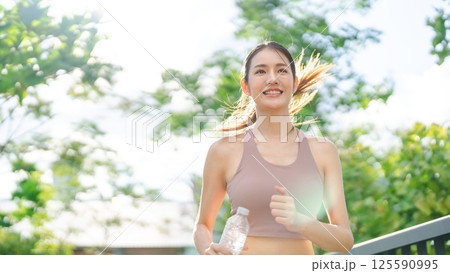 Southeast young asian woman running cardio exercise at outdoor with sunlight 125590995